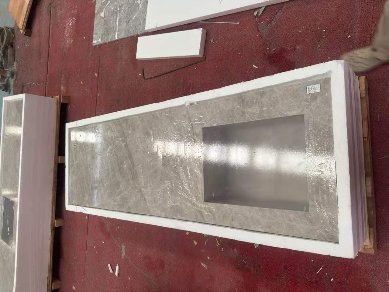 Finished integrated stone sink countertop positioned inside a custom-shaped foam liner for handling and export protection Finished integrated stone sink countertop positioned inside a custom-shaped foam liner for handling and export protection